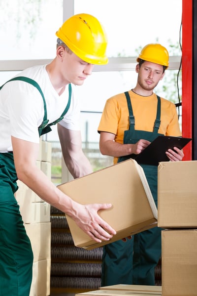 Young supervisor and warehouse worker during job Young supervisor and warehouse worker during job
