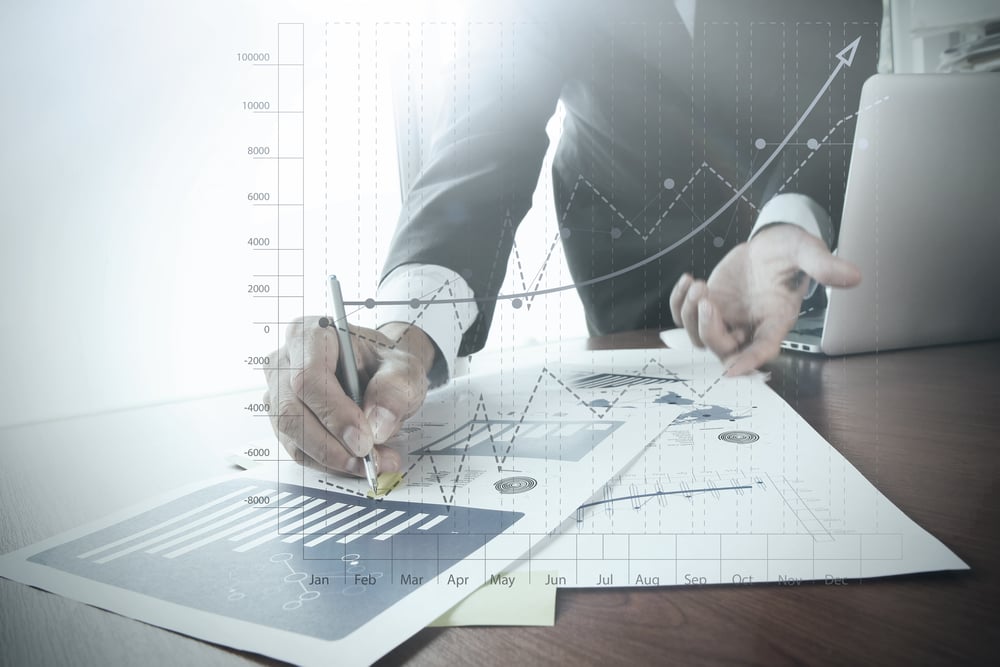 close up of businessman hand working on laptop computer with business graph information diagram on wooden desk as concept close up of businessman hand working on laptop computer with business graph information diagram on wooden desk as concept